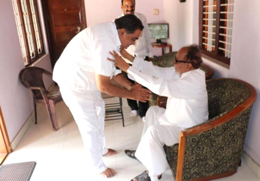 Ramanath rai seeking blessings of Janardhana Poojary